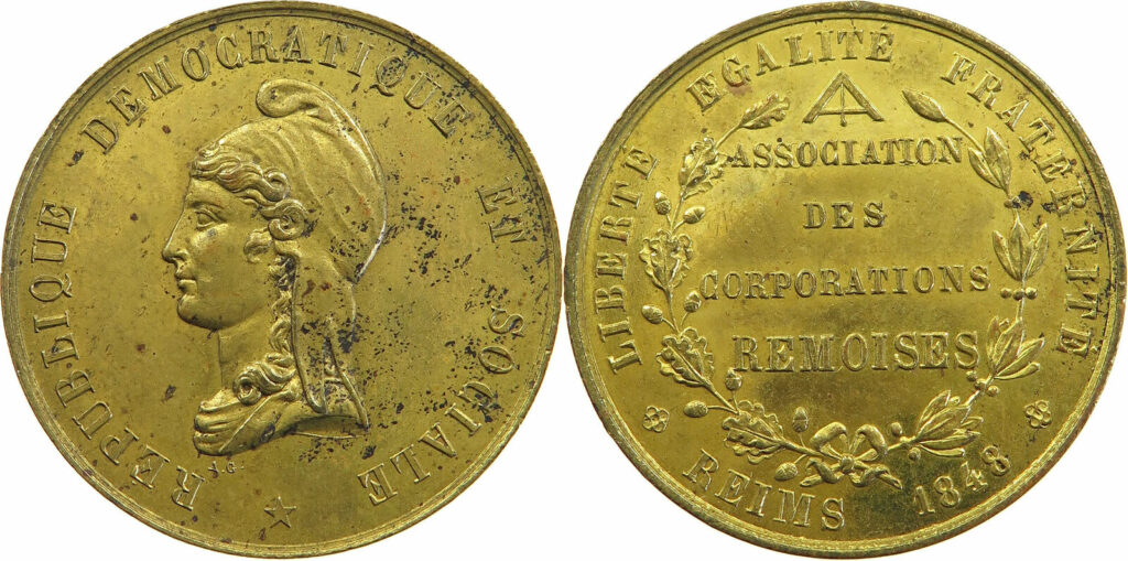 Two sides of a gold-toned medal: left side shows a profile bust of a woman facing left with inscriptions along the rim; right side shows decorative plant motif and the words 'ASSOCIATION DES CORPORATIONS' with a floral wreath and surrounding text along the edge.