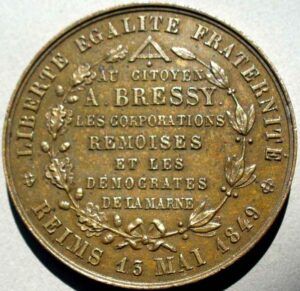 Bronze medallion with laurel wreaths and French text, including 'A. BRESSY' and 'DEMOCRATES DE LA MARNE', dated 1849 on the edge