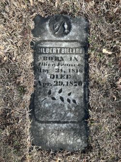 Weathered grave marker partially buried in grass, reading 'Gilbert Billard' with birth and death dates from the 1800s.